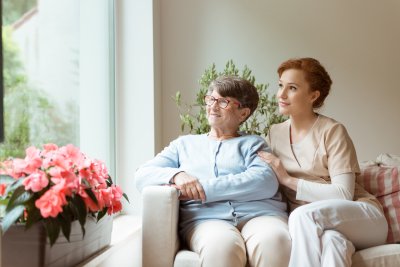 senior woman with female caregiver smiling